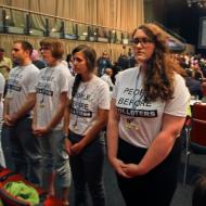 Youth from the Canadian Youth Delegation turn their back on Environment Minister Peter Kent during his remarks in Durban Climate talks.